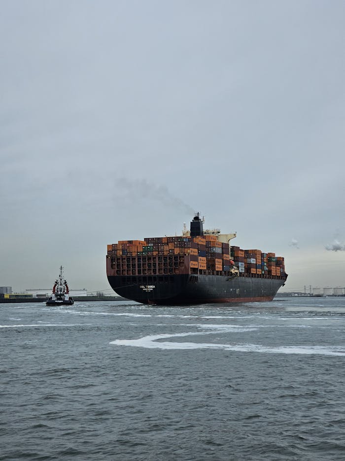 Large container ship navigating the waters of Maasvlakte Port in Rotterdam, Netherlands.